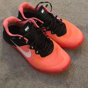 Coral and black nike metcons